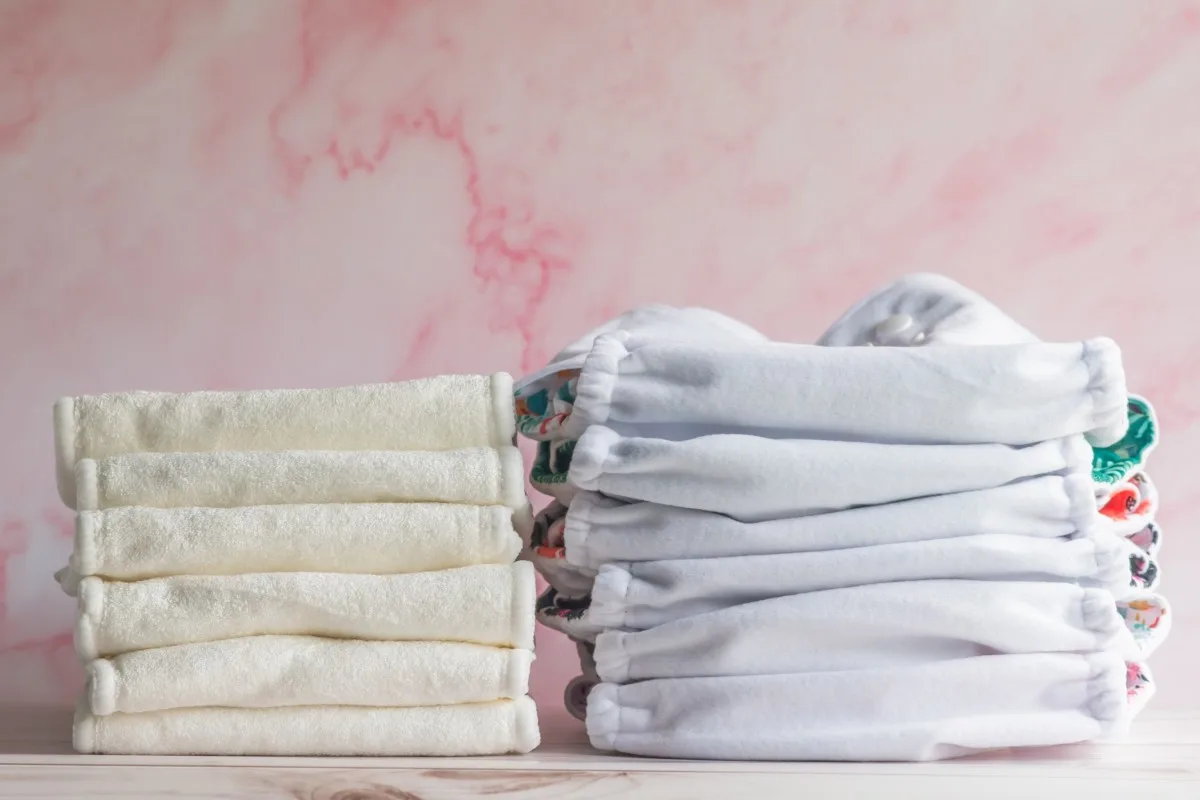 A stack of cloth diapers with covers.