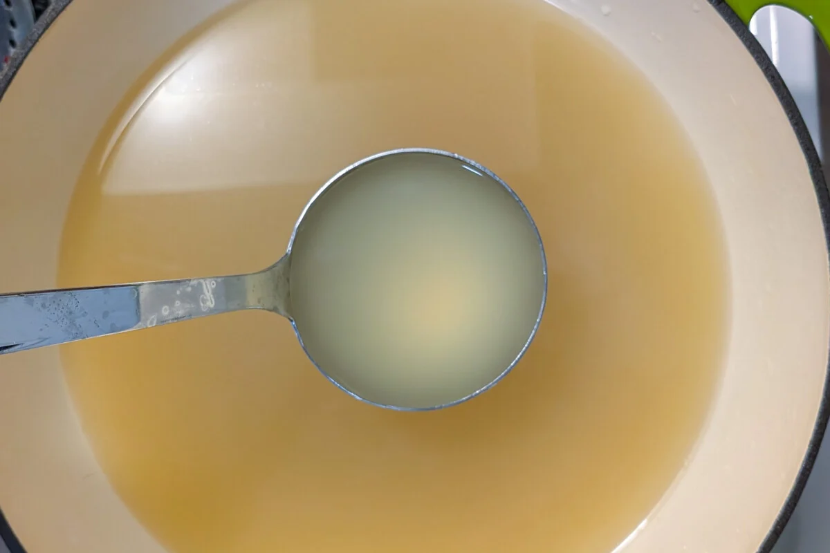 Pot with corn broth and a ladle full