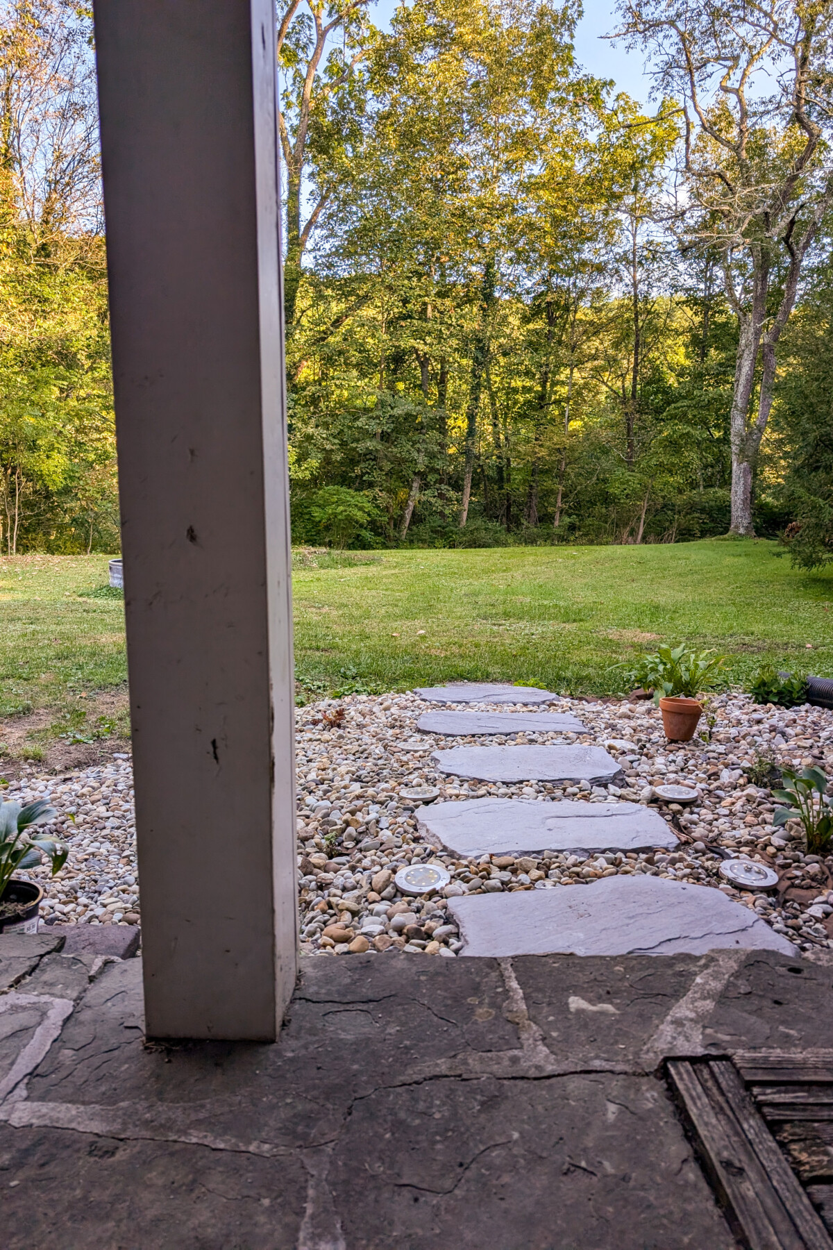 View from patio of gravel flower beds with stone walkway