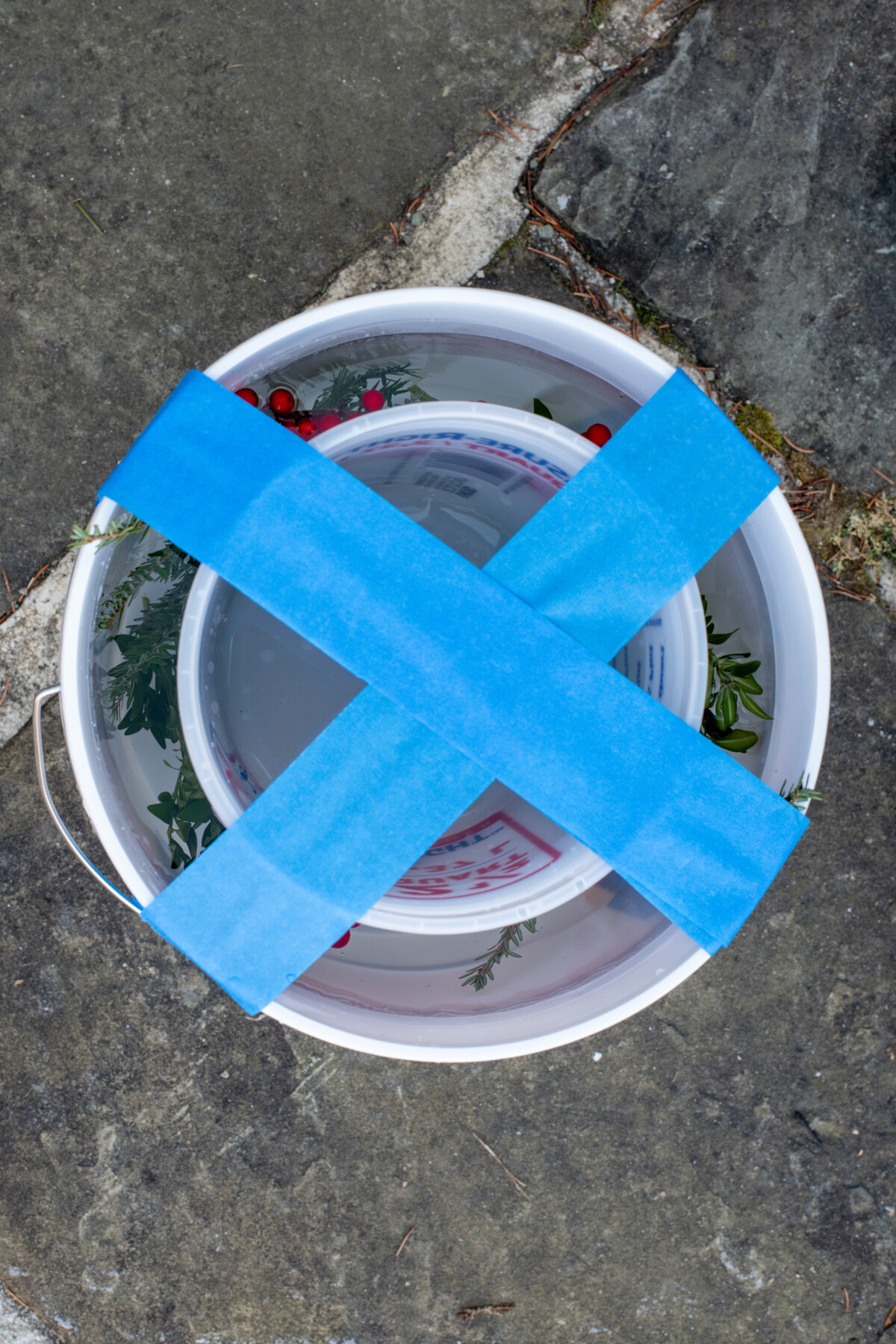 Smaller bucket taped inside a larger bucked and filled with water