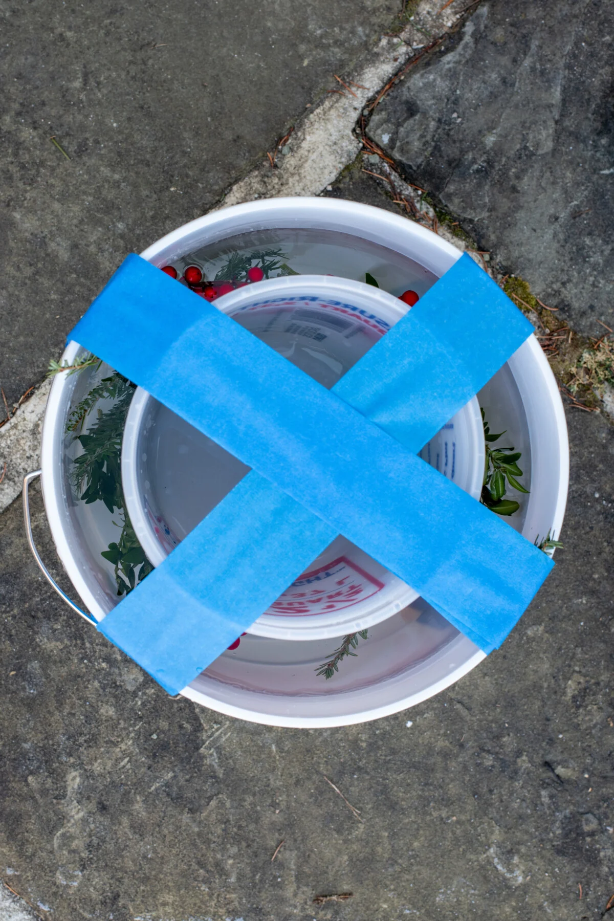 Smaller bucket taped inside a larger bucked and filled with water