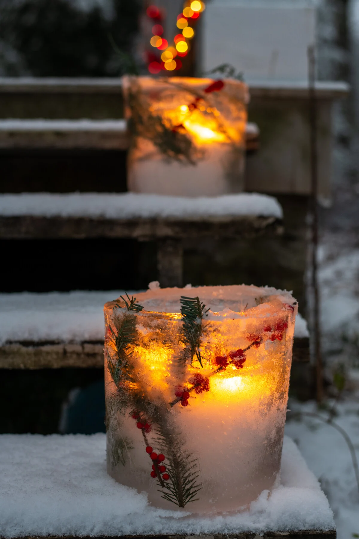 Two ice luminaries on porch steps